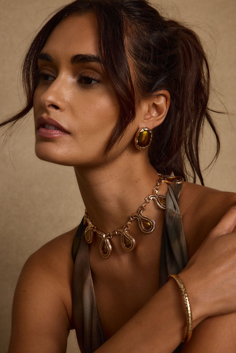 Close-up of the Tavi Gold Choker showcasing the fabric texture and design details.