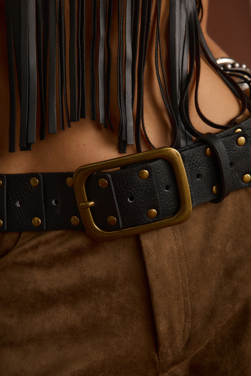 Tempest Black Studded Belt shown as part of a styled outfit ensemble.