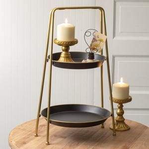 Two-tiered round tray with elegant black and gold finish, ideal for home decor or entertaining, adding sophistication to any room.
