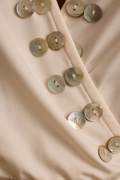 Close-up of mother-of-pearl shell buttons on the ivory Venice halter top.