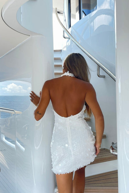 Back view of the white mini dress showing the silhouette and fit.