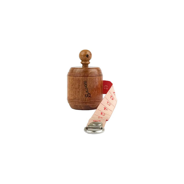 Wooden measuring tape with red ribbon open on white background.